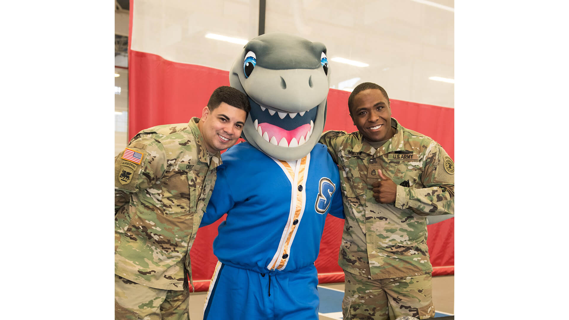 Photo of two active veterans and Finn the shark.